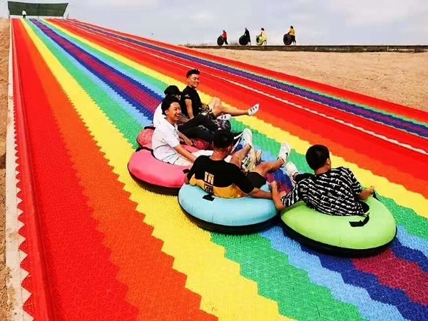 What should be noted when sliding on a rainbow slide